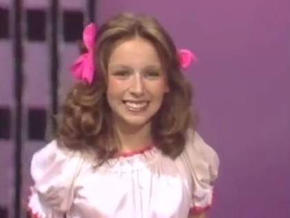 Lena Zavaroni as Sandy Olsson from the musical Grease.